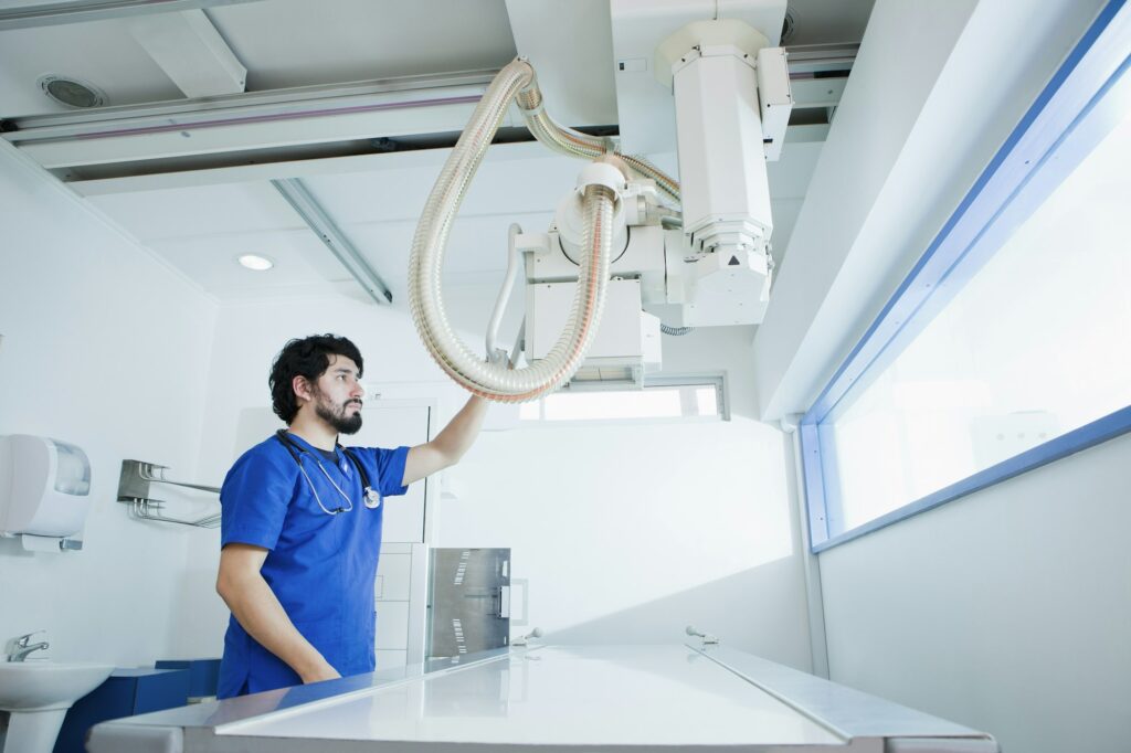 Healthcare professional operating Xray equipment in a clean and modern clinic.